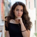 selective focus photography of woman wearing black off-shoulder blouse